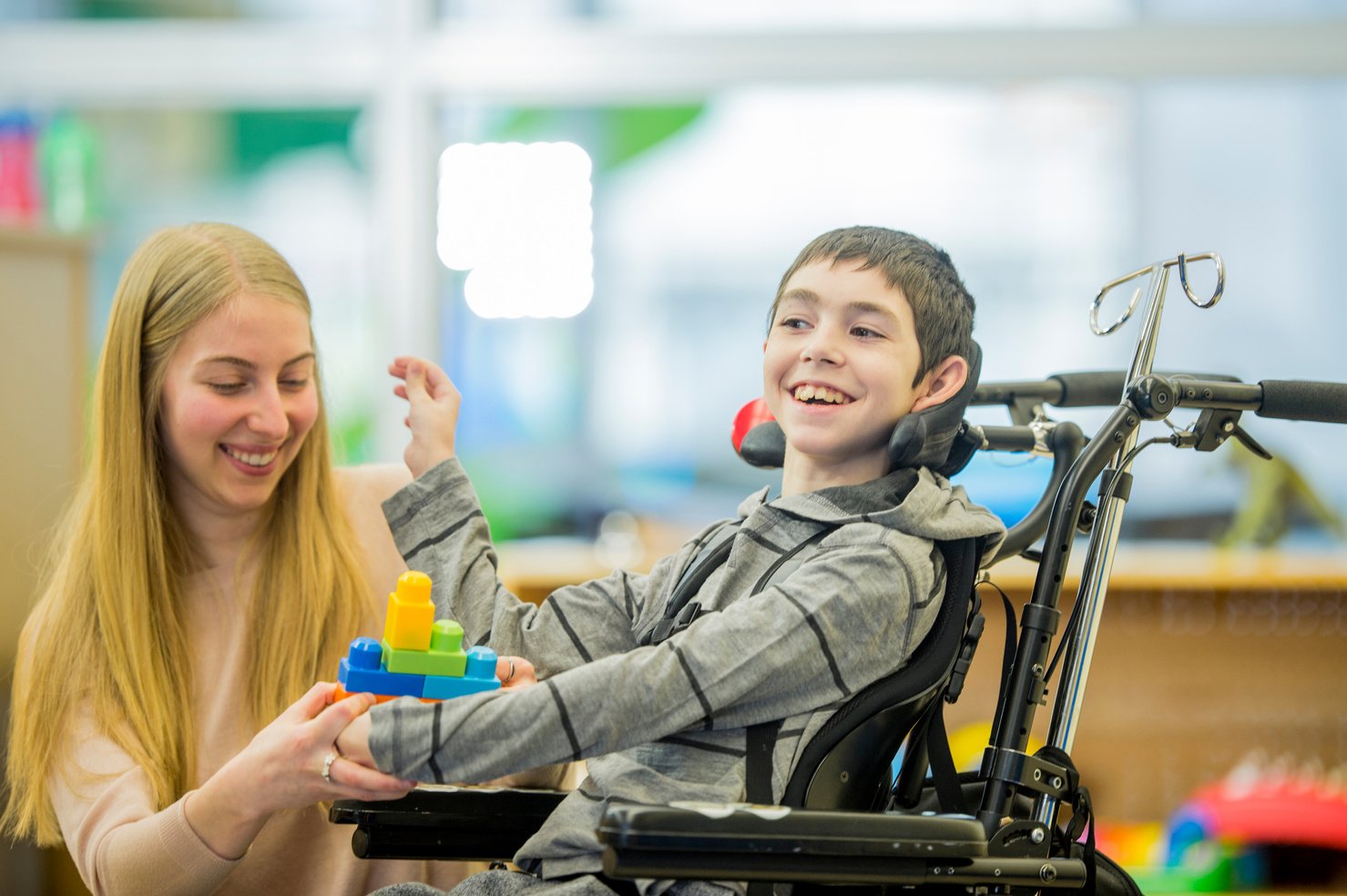 Caregiver Playing with a Disabled Child